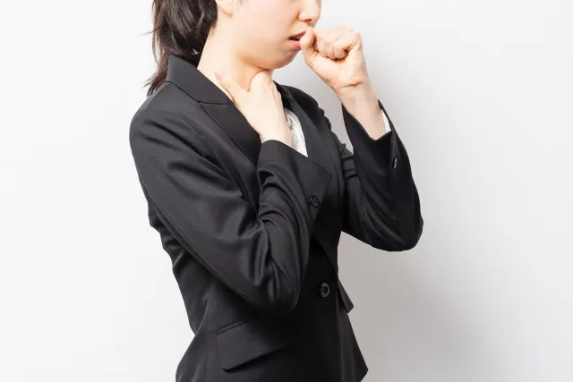 風邪をひいて咳こむ女性